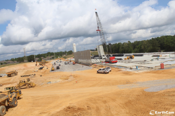 A crane tilts up concrete panels at Calera Commerce Park, visible from I-65. This 216,000 square foot development is 50% pre-leased to Sunbelt Paper & Packaging.